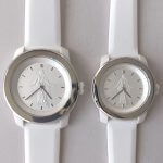 Close-up of silver Christus wristwatch with white face and image of the Christus statue at center