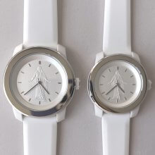 Close-up of silver Christus wristwatch with white face and image of the Christus statue at center