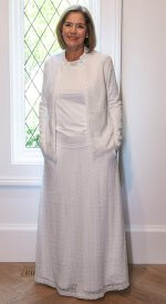 Elegant white lace LDS Temple suit featuring a zip-up jacket with pockets and a flowing A-line skirt